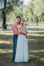 Bride and groom at wedding Day walking Outdoors on spring nature. Bridal couple, Happy Newlywed woman and man embracing Royalty Free Stock Photo