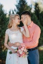 Bride and groom at wedding Day walking Outdoors on spring nature. Bridal couple, Happy Newlywed woman and man embracing Royalty Free Stock Photo