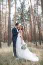 Bride and groom at wedding Day walking Outdoors on summer nature. Bridal couple, Happy Newlywed woman and man embracing in green Royalty Free Stock Photo