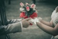 Bride and groom wedding flowers in hand - sepia tone