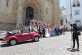 Bride, groom and wedding guests in front of the church Se Velha