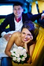 Bride and groom in wedding limousine