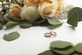 Wedding rings with roses on white background Royalty Free Stock Photo