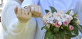 The bride and groom with wedding rings on their fingers hold a bouquet Royalty Free Stock Photo