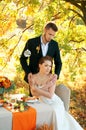 Bride and groom at the wedding table. Autumn outdoor setting. Royalty Free Stock Photo