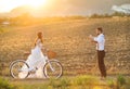 Bride and groom with a white wedding bike