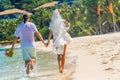 bride and groom, young loving couple, on their wedding day, outdoor beach wedding on tropical beach and sea background Royalty Free Stock Photo