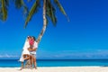 bride and groom, young loving couple, on their wedding day, outdoor beach wedding on tropical beach and sea background Royalty Free Stock Photo