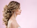 Bride Hairstyle and Make up. Woman Bridal Pinned Hair Curls. Model with Low Ponytail Evening Hairdo over Pink Background