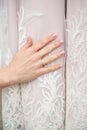 Bride hand with beautiful diamond ring on white dress. wedding manicure Royalty Free Stock Photo