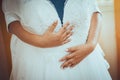 Bride hands holding her wedding dress