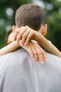 The bride hands her husband a hug around the neck close up. Wedding ring on her finger Royalty Free Stock Photo