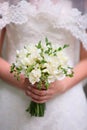 Bride hands holding beautiful wedding bouquet