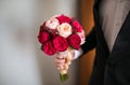 Bride hands with Wedding beautiful bouquet close-up