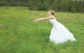 Bride hastens towards to groom on meadow Royalty Free Stock Photo