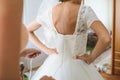 The bride is helped to wear a wedding dress, lace corset Royalty Free Stock Photo