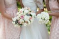 The bride and her bridesmaid in pink with flowers at the wedding, With bouquets in hand Royalty Free Stock Photo