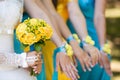 Bride and her bridesmaids with bracelets on hands