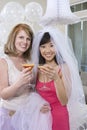 Bride And Her Friend Holding Juice Glasses