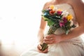 Bride with her wedding dress sitting holding a bouquet of flowers, with copy space Royalty Free Stock Photo