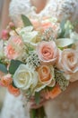 A bride is holding a beautiful bouquet of pink and white roses Royalty Free Stock Photo