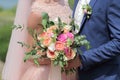 Bride holding a beautiful bridal bouquet. Wedding bouquet of peach roses by David Austin, single-head pink rose aqua, eucalyptus, Royalty Free Stock Photo