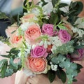 Bride holding a beautiful bridal bouquet. Wedding bouquet of peach roses by David Austin, single-head pink rose aqua, eucalyptus Royalty Free Stock Photo