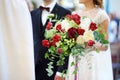 Bride holding a beautiful wedding bouquet during wedding ceremony in a church Royalty Free Stock Photo