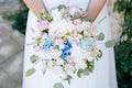 Bride holding beautiful wedding bouquet.with white, blue, pink flowers Royalty Free Stock Photo