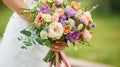 A bride holding a bouquet of flowers in her hand Royalty Free Stock Photo