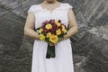 Bride holding bouquet of yellow roses