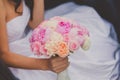 Bride holding bright wedding peony bouquet