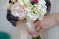 Bride Holding a Colorful Wedding Flower Bouquet of White Hydrangea, Peonies and Roses Royalty Free Stock Photo