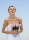 Bride Holding Flower Bouquet Against Clear Blue Sky Royalty Free Stock Photo