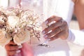 Bride holding a glass of champagne and wedding bouquet