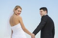 Bride Holding Groom's Hand Against Clear Blue Sky Royalty Free Stock Photo