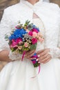 Bride is holding a large bright wedding bouquet