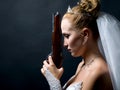 Bride holding old gun Royalty Free Stock Photo