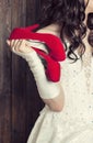 Bride holding a pair of red shoes Royalty Free Stock Photo