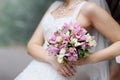 Bride holding pink wedding flowers bouquet