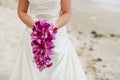 Bride holding purple orchid flower wedding bouquet Royalty Free Stock Photo