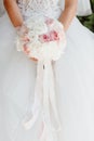 Bride Holding Wedding Bouquet of Beautiful Flowers