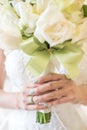 Bride holding wedding bouquet flowers of roses. Royalty Free Stock Photo