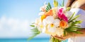 Bride holding wedding bouquet with mix of orange roses, white calla lilies, and pink orchids on serene beach backdrop Royalty Free Stock Photo