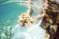 Bride holding wedding bouquet underwater Royalty Free Stock Photo
