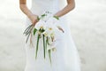 Bride holding white orchid flower wedding bouquet