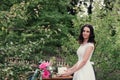 Bride holding a white wedding cake decorated flowers Royalty Free Stock Photo