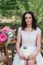 Bride holding a white wedding cake decorated flowers Royalty Free Stock Photo