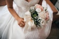 Bride holds a beautiful wedding bouquet of pink and white flowers in her hands Royalty Free Stock Photo