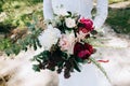 Bride holds beautiful wedding bouquet with red peonies and eucalyptus leaves in rustic and boho style Royalty Free Stock Photo